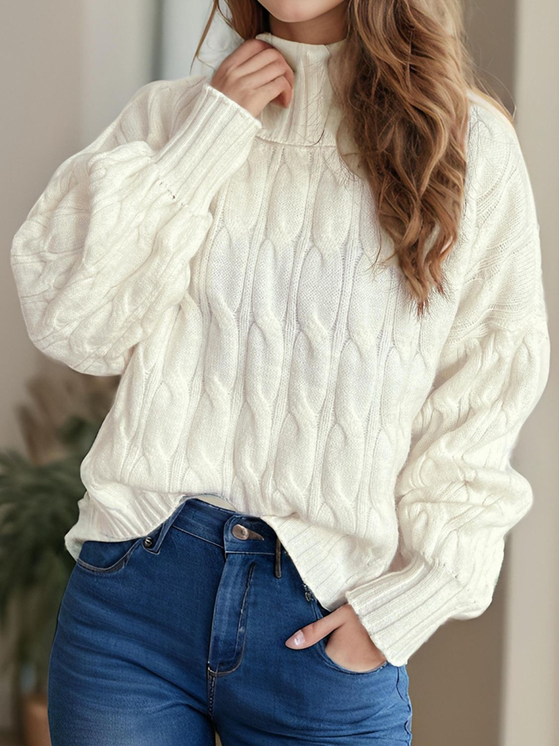 Ivory oversized cable knit turtleneck pullover sweater with balloon sleeves.