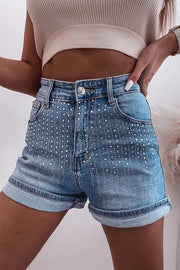 Embellished denim high-rise shorts in medium wash with cuffed hems and rhinestone details.