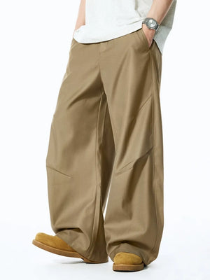 Men's relaxed fit oversized sweatpants in deep khaki with unique paneling details.