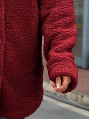Teddy-texture shacket in wine with button detail and cuffed sleeves.