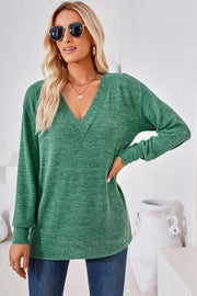Green heathered tunic top with a relaxed V-neck and long sleeves.