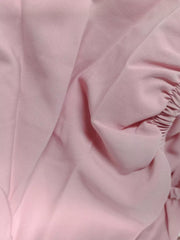 Pink midi dress with puff sleeves and tie front detail.