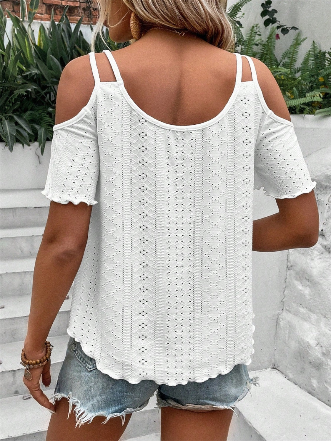 White eyelet cold shoulder blouse with scalloped hem and short sleeves.