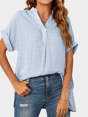 Light blue linen blend blouse with short sleeves, V-neck, and subtle plaid texture.