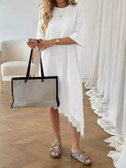 White asymmetrical t-shirt dress with lace trim and short sleeves.