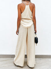Cream pleated palazzo pants and cami set with a relaxed fit.