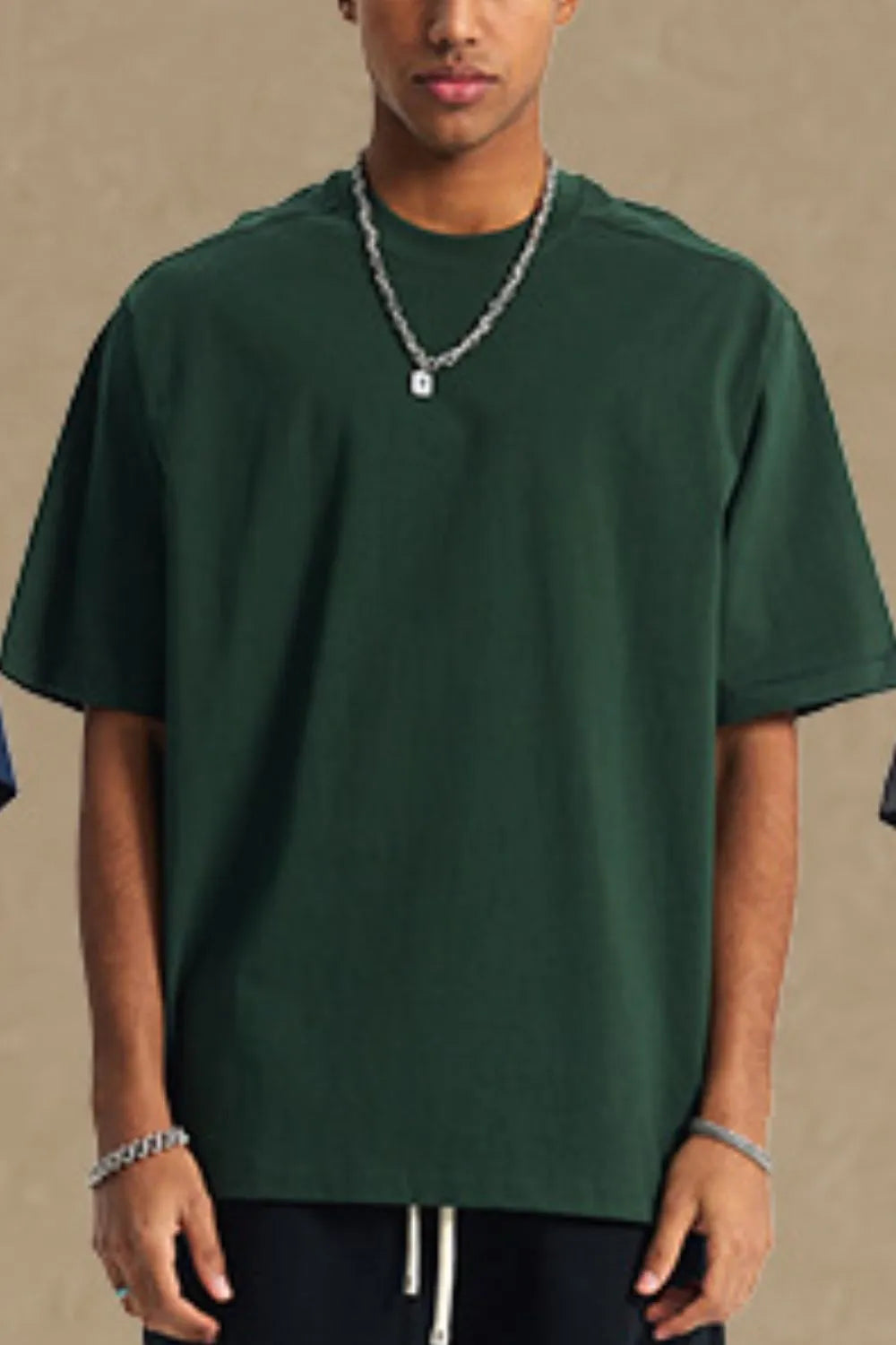 Dark green boxy cut t-shirt with crew neck and short sleeves.