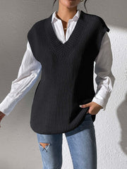 Black textured knit V-neck sleeveless top over a white collared shirt.