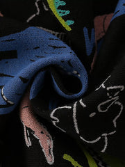 Black crew neck sweatshirt with a colorful dinosaur print and textured knit detail.