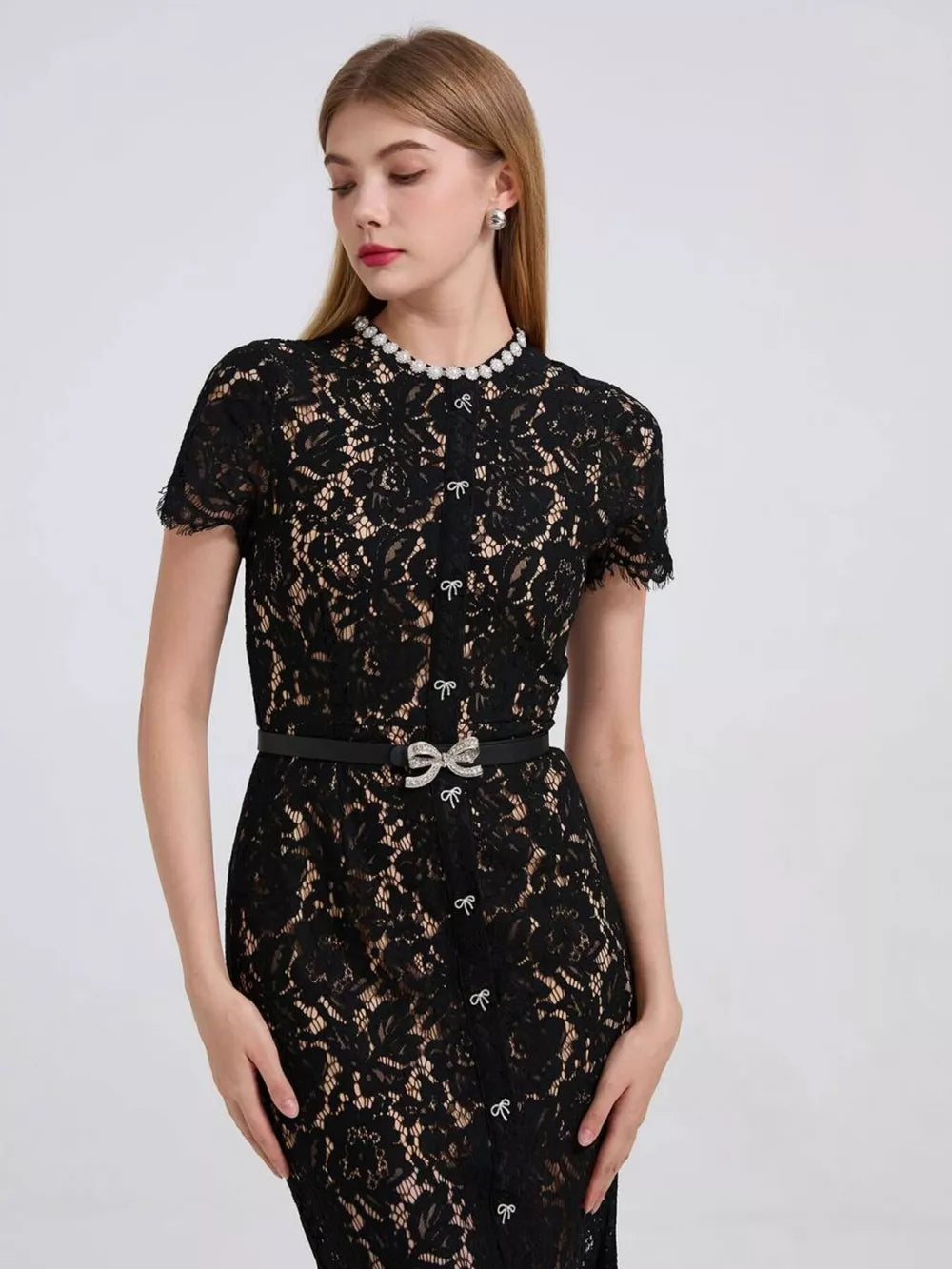 Black floral lace mermaid dress with pearl collar and jeweled bow belt.