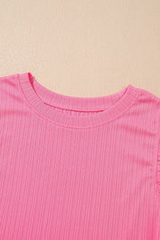 Pink ribbed knit top with ruffled sleeve detail
