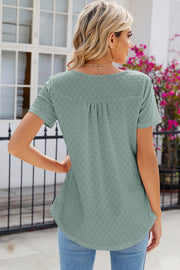 Sage eyelet yoke gathered henley shirt with short sleeves and a curved hem.