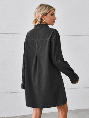 Black oversized denim shirt dress with button cuffs and a back pleat detail.
