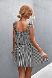 Black and white striped mini dress with ruffle yoke and tiered skirt.