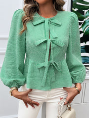 Green gingham peplum blouse with bow details and puff sleeves