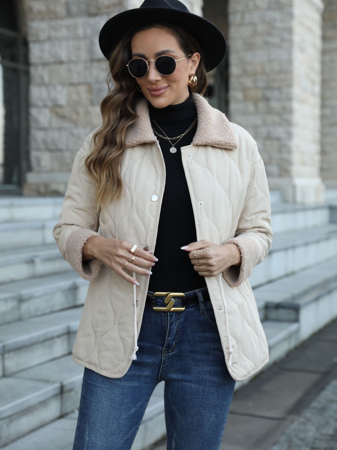 White quilted sherpa collar jacket with drawstring detail and button closure.