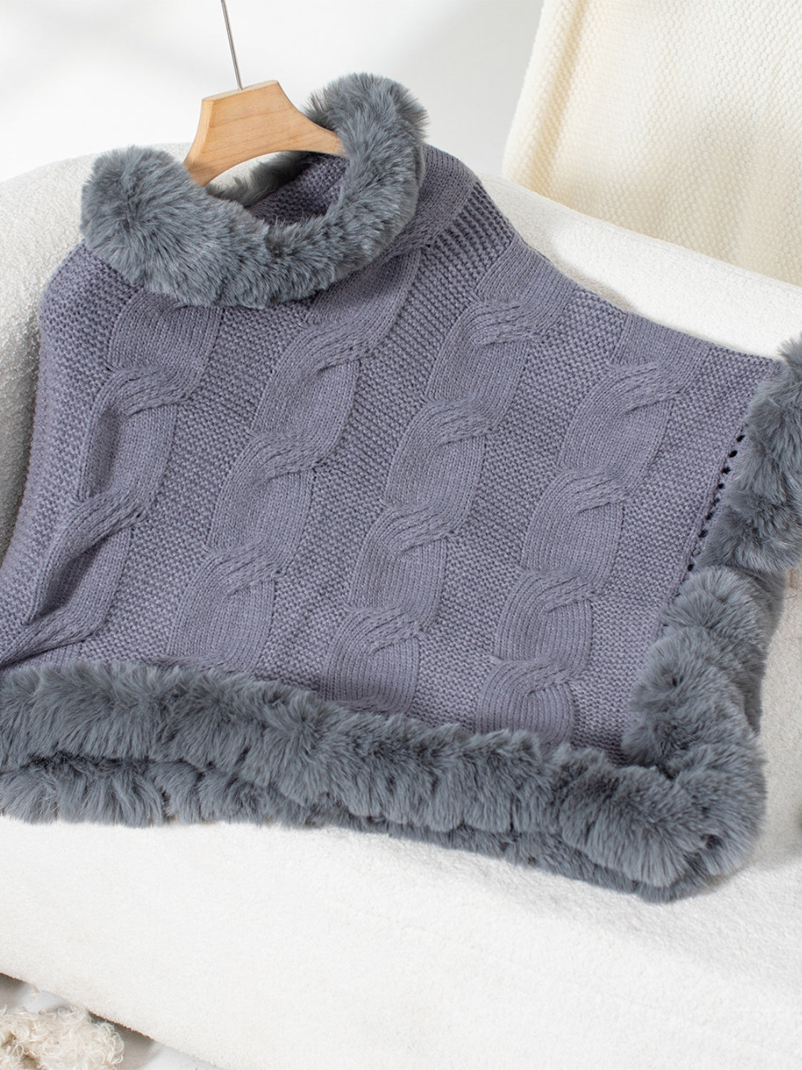 Dark Gray cable knit acrylic poncho with faux fur trim and cowl neck.