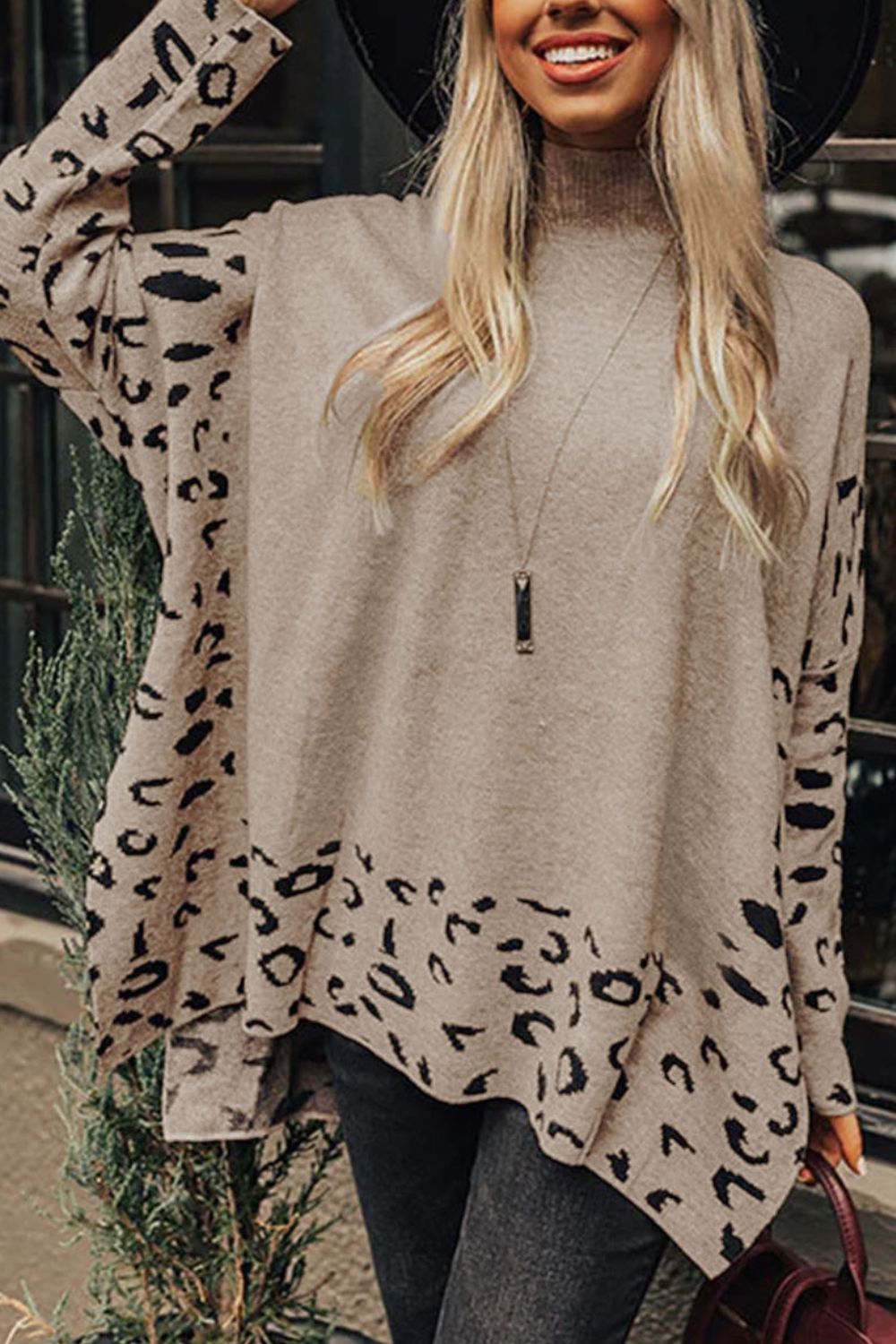 Asymmetric leopard panel knit sweater in khaki with a mock neck and long sleeves.