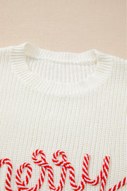 Ivory knit sweater with red and white candy cane script detail.