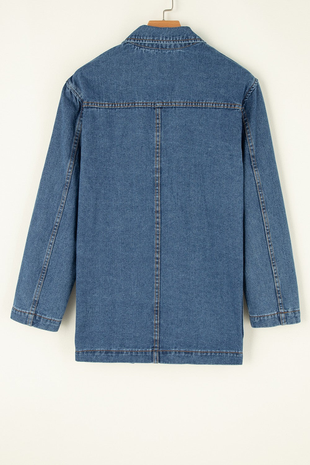 Medium wash denim blazer with double-breasted cut and contrast stitching.