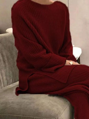 Burgundy ribbed knit sweater and pants set with crew neck and side slits.