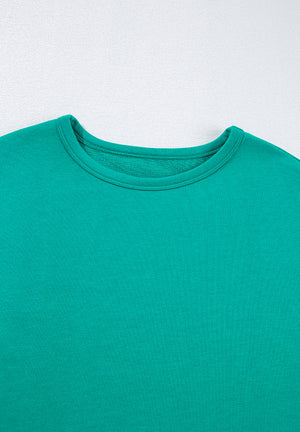 Turquoise crewneck sweatshirt with a relaxed fit and ribbed neckline detail.