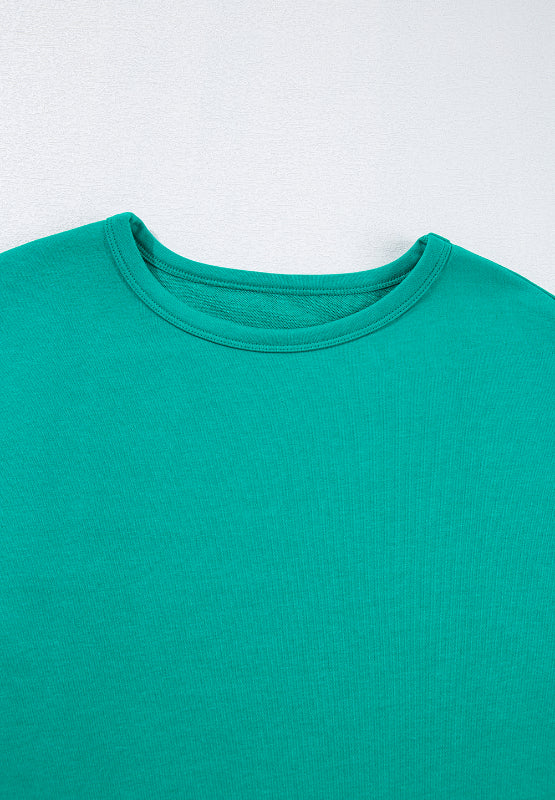 Turquoise crewneck sweatshirt with a relaxed fit and ribbed neckline detail.
