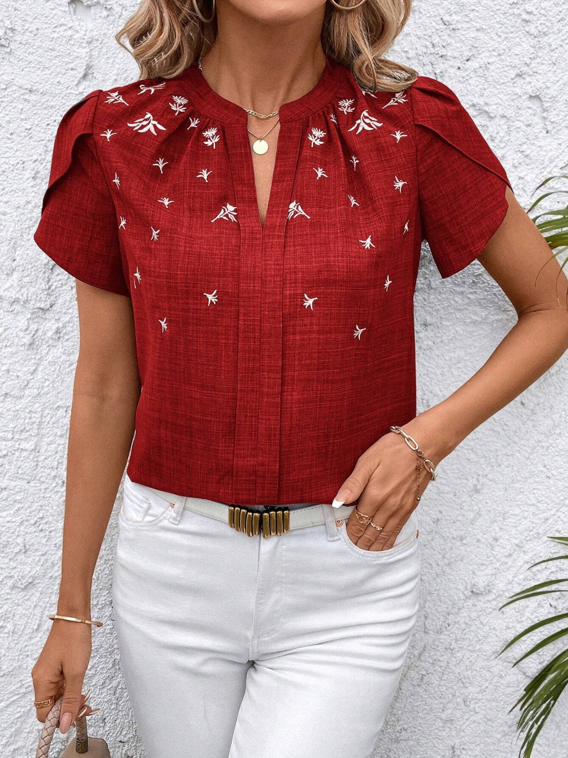Rust embroidered floral keyhole blouse with short sleeves and a split neckline.
