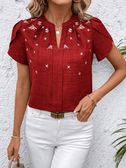 Rust embroidered floral keyhole blouse with short sleeves and a split neckline.