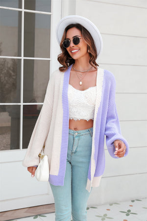 Colorblock knit cardigan in cream and lavender with contrast trim and balloon sleeves.