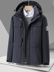 Dark grey hooded puffer jacket with multiple pockets and embroidered text detail.