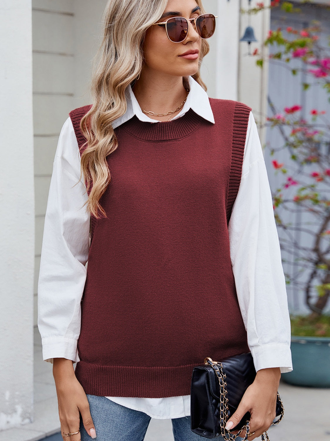 Burgundy ribbed knit vest with crew neck and side buttons, styled over a white shirt.