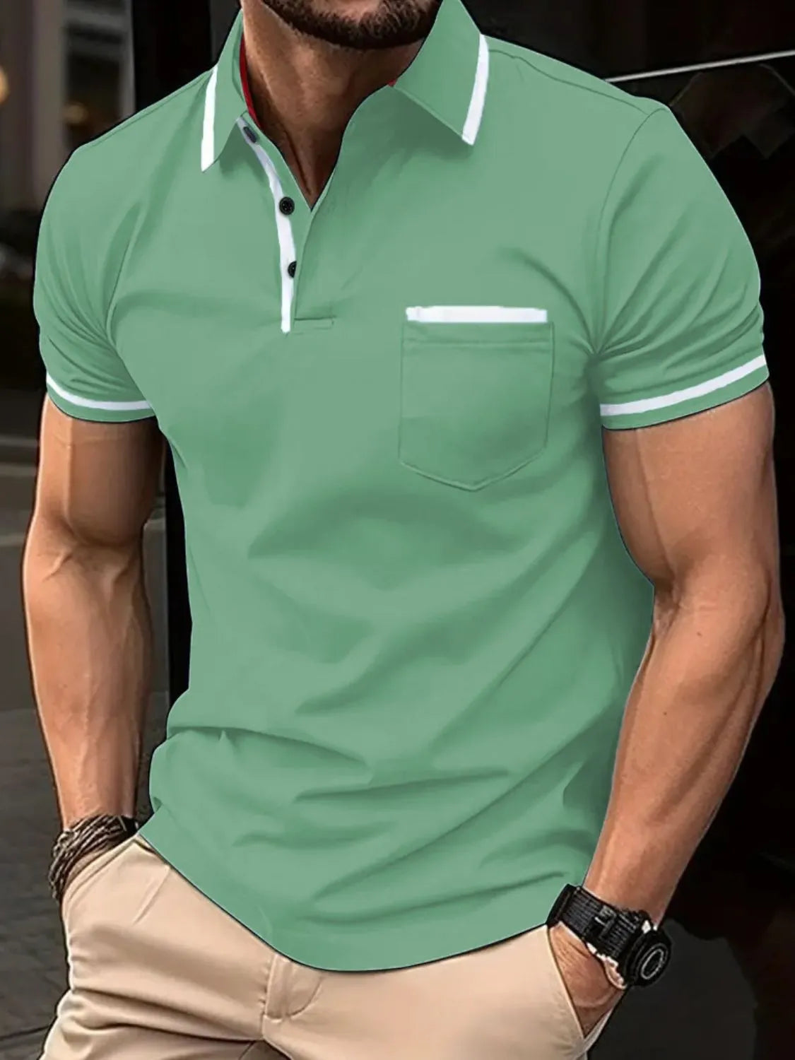 Green short sleeve polo shirt with white contrast trim on collar, pocket, and sleeves.