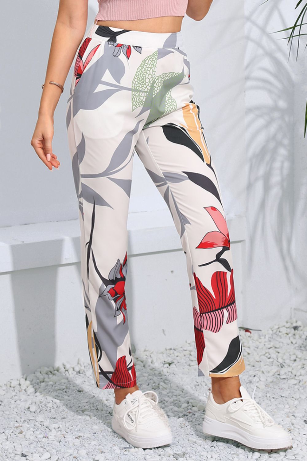 Botanical print slim-fit trousers in floral with a high waist and straight leg, styled with white sneakers.