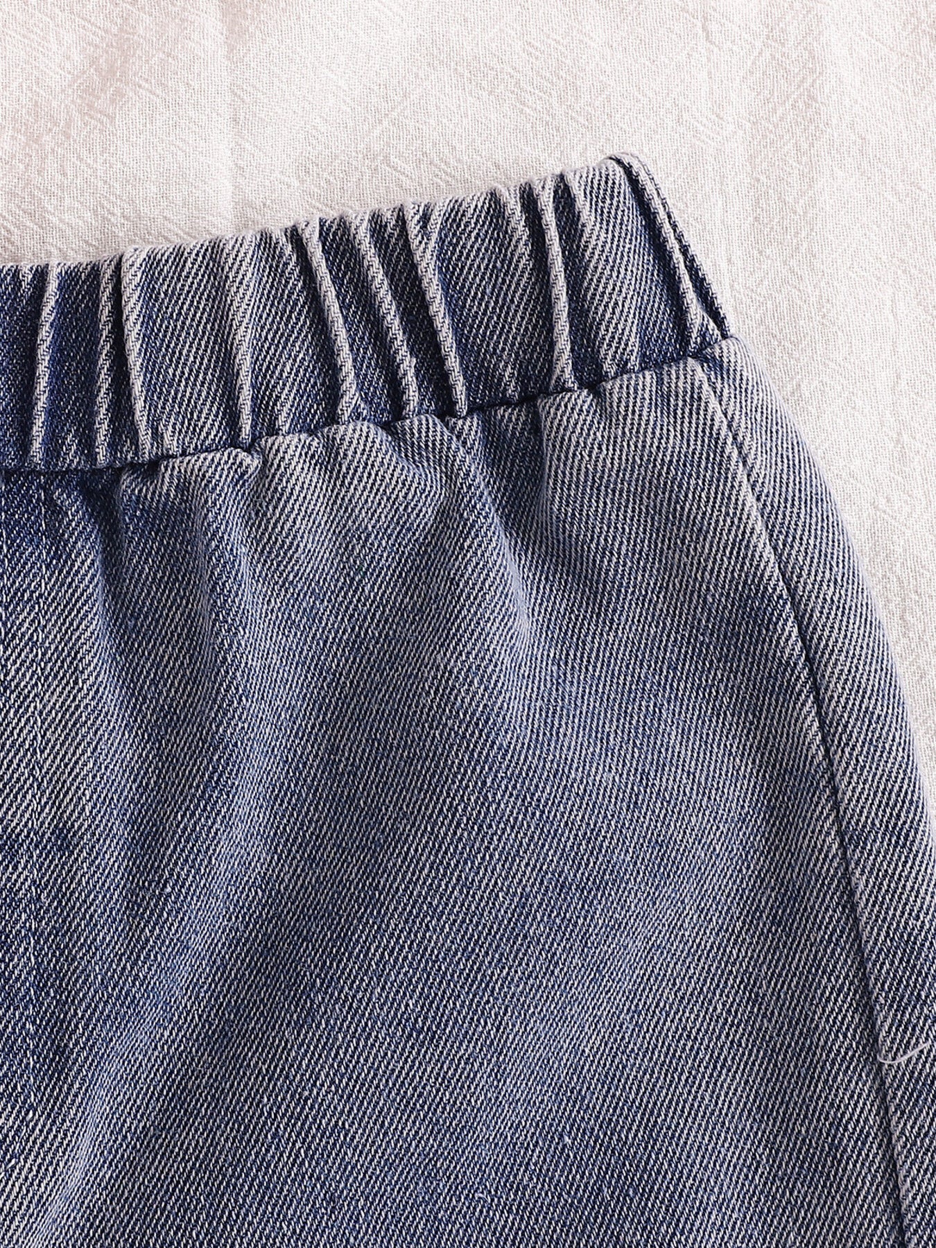 Distressed denim shorts with elastic waistband