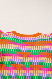 Geometric knit top with flutter sleeves in orange and green colorway.