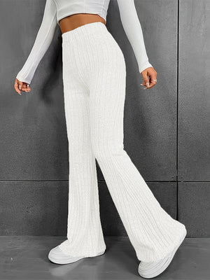 White ribbed flare trousers in 100% polyester with a high waist and bootcut leg.