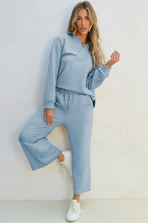 Light blue textured polo sweatshirt and wide-leg culottes set with a geometric pattern.