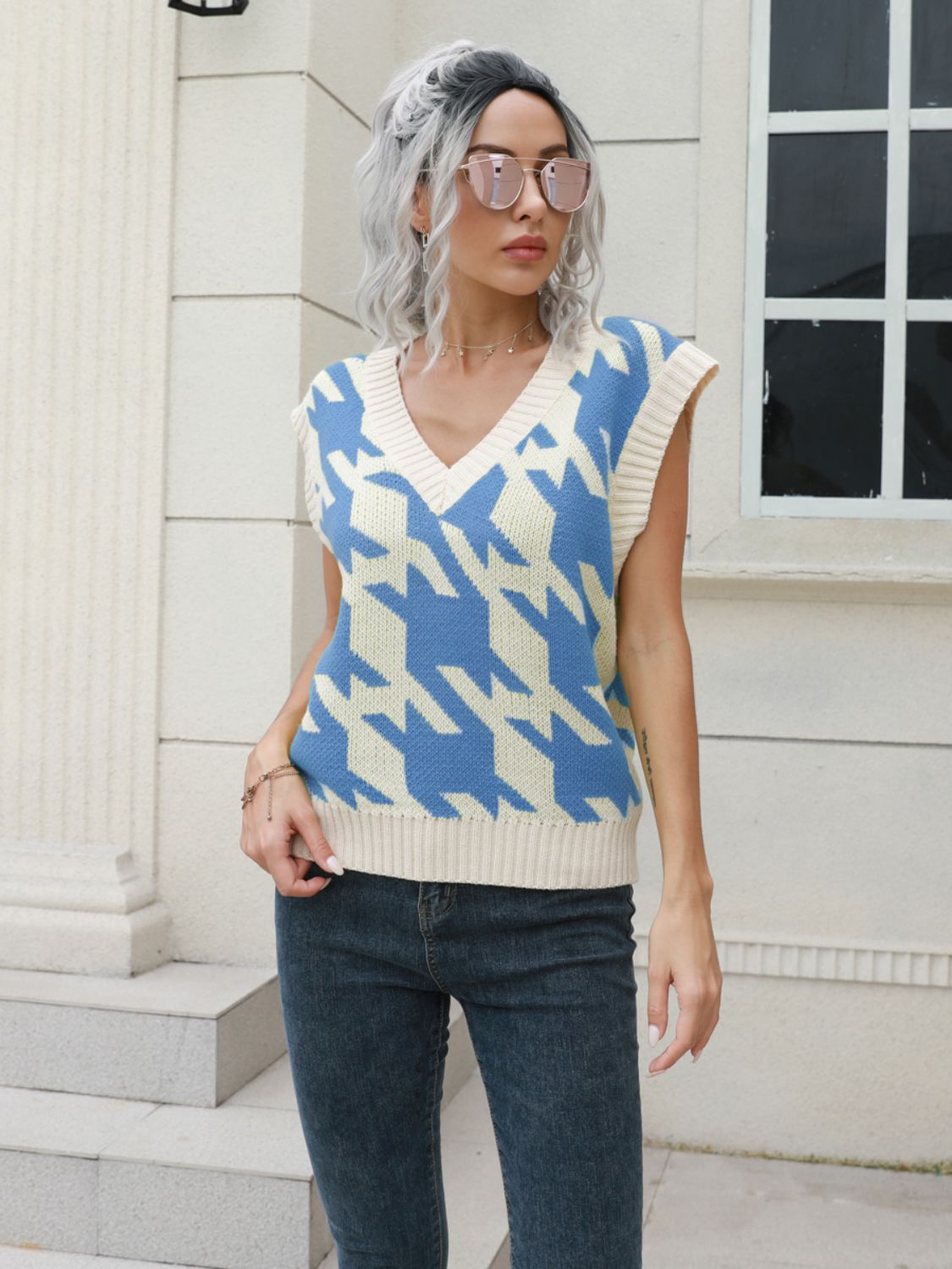 Houndstooth knit v-neck pullover vest in Azure and cream acrylic, sleeveless.