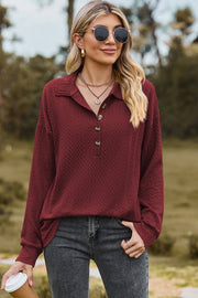 Burgundy textured polo-neck sweater with button detail and long sleeves.