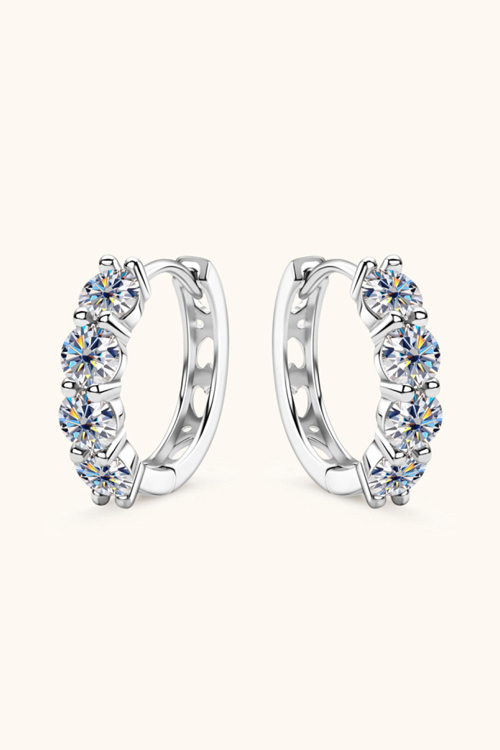 Silver pavé crystal huggie earrings with five round-cut stones each.