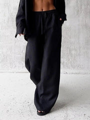 Black relaxed fit wide leg pants with drawstring waist and button-up shirt.