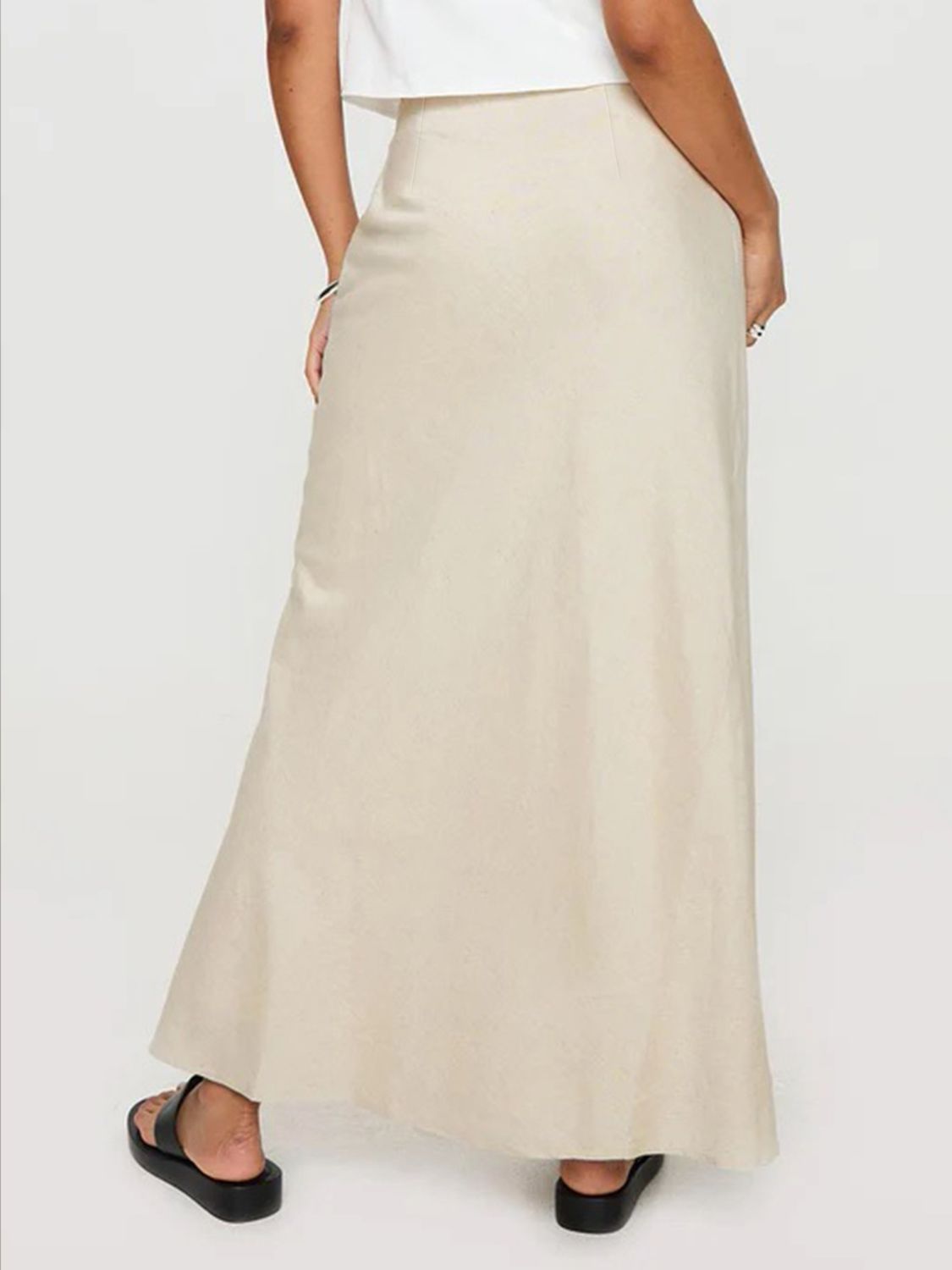 Beige bias-cut maxi skirt with a flowing A-line silhouette.