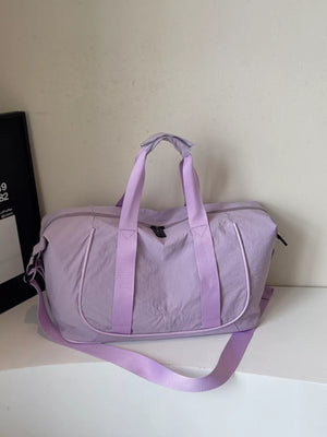 Premium lightweight Oxford cloth duffel bag in purple with dual handles and a crossbody strap.