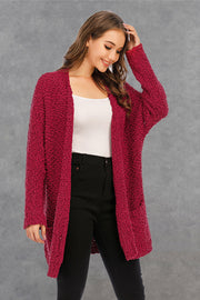 Burgundy textured cocoon cardigan with patch pockets and open front.