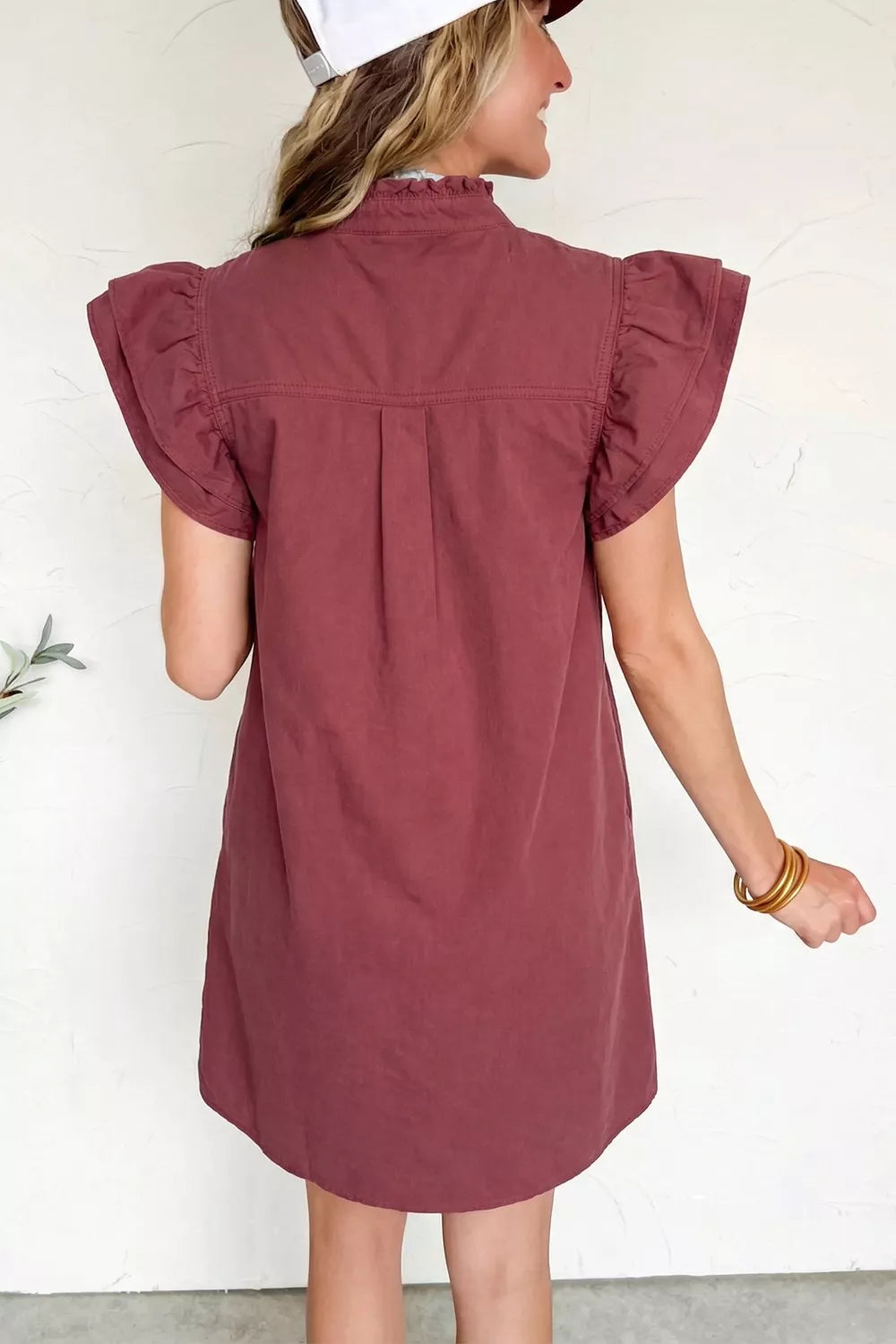 Ruffled sleeve denim mini dress with button-down front and high neckline.