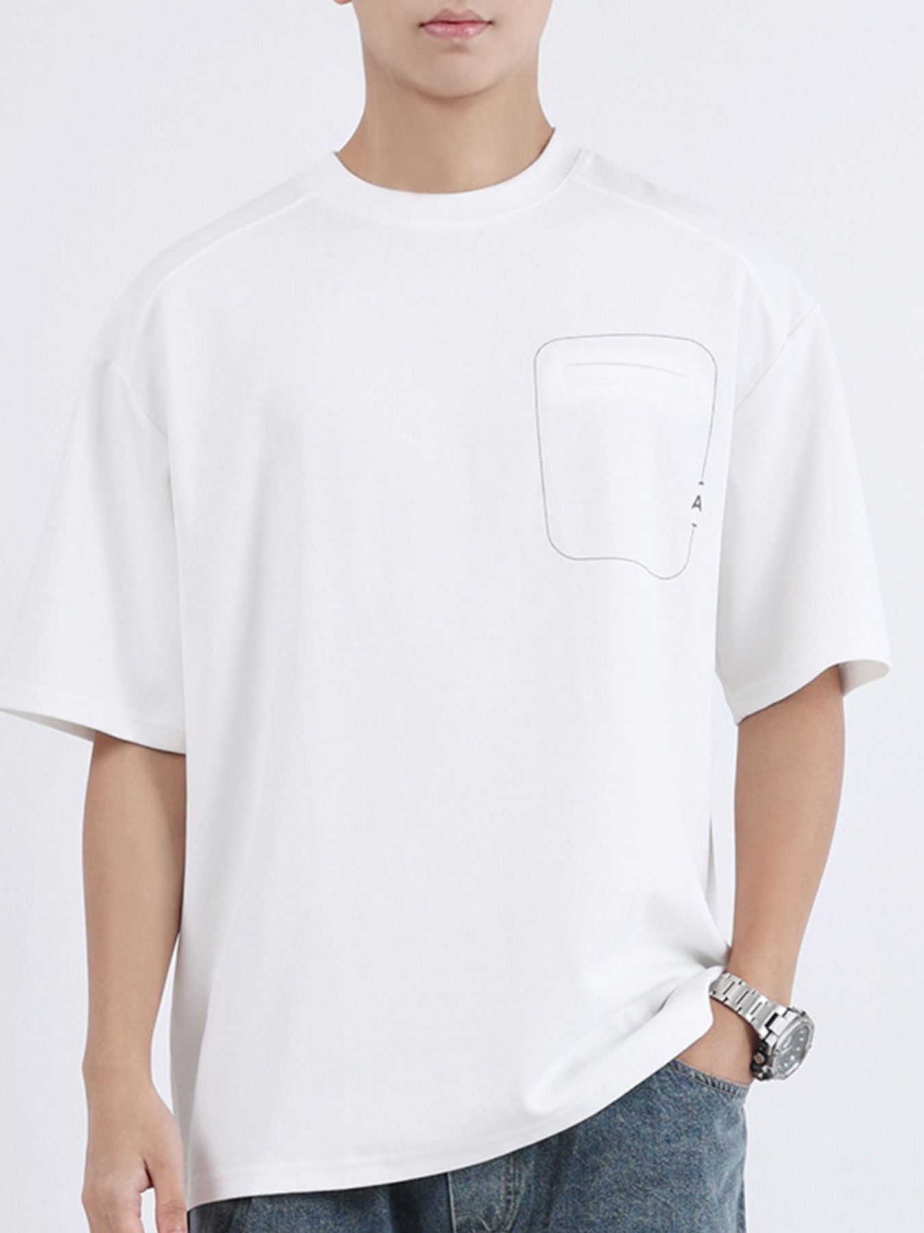 White cotton crew neck t-shirt with decorative pocket detail and half sleeves.