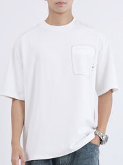 White cotton crew neck t-shirt with decorative pocket detail and half sleeves.