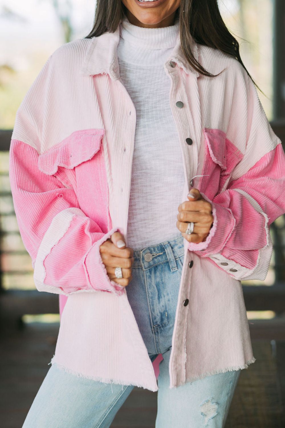Colorblock corduroy shacket in blush pink with raw edges and button front.