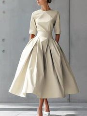 Camel A-line midi dress with a pleated skirt and short sleeves.